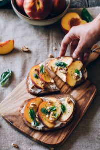 Delicious vegan toast with peaches, walnuts, basil and chia seeds